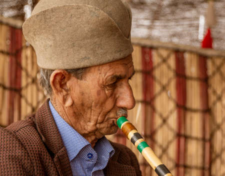 Shiraz, Iran - 2019-04-09 - Qashgal man plays traditional flute musical instrument.のeditorial素材