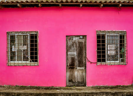 La Entrade, Ecuador - September 14, 2018 - unpainted door on red wallのeditorial素材