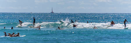 Honolulu, Hawaii - Nov 6, 2021-Young boys play on their boogey boards in the surf.