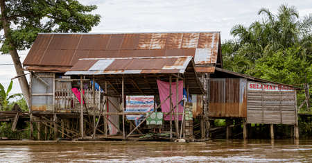 Central Kalamantan, Indonesia; May 20, 2022 - homes seen from the river that are dilapidated and ready to collapse.の写真素材