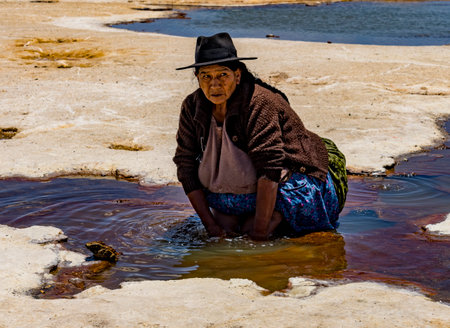 Uyuni, Bolivia, 01182023 - Women soak their feet in the mineral water of the Bolivian Salt Flats.のeditorial素材