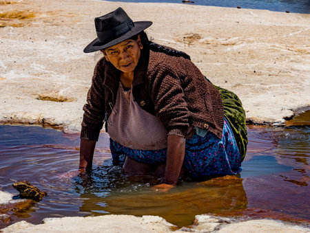 Uyuni, Bolivia, 01182023 - Women soak their feet in the mineral water of the Bolivian Salt Flats.のeditorial素材