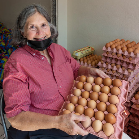 Cuenca, Ecuador, 12222021 - Soup Kitchen helpers eggs for meals.のeditorial素材