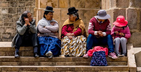 Copacabana, Bolivia, 01172023 - Bolivian people sitting amd talking on steps.のeditorial素材