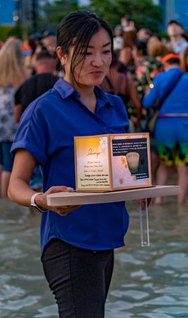 hawaii, honolulu - 20230530: Shinnyo Floating Lantern Festival - people carry their personal lantern to the ocean with wishes written for their dear departed dead.のeditorial素材