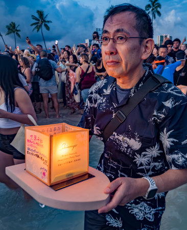 hawaii, honolulu - 20230530: Shinnyo Floating Lantern Festival - people carry their personal lantern to the ocean with wishes written for their dear departed dead.のeditorial素材