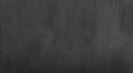 Sleek and tidy black wall surface. Textured background photo. With intricate details for banner, poster and website background.の写真素材