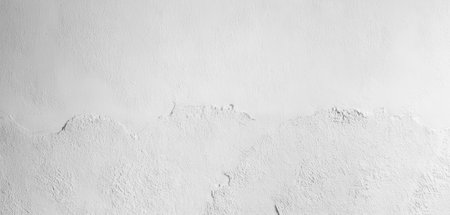 Rough texture on a smooth white surface. Realistic wall photo background, With detailed and sharp texture. Background for banners.の写真素材
