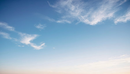 Picturesque view of a bright blue sky with wispy white cirrus clouds. Background photos for banners, posters and wallpapers.の写真素材