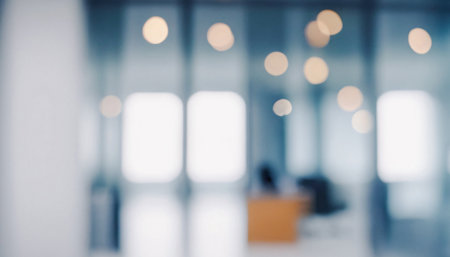Blurred image depicting a modern and bright office space with bokeh lights and subtle color tones. Premium modern bokeh photos for poster, banner and print backgrounds.の写真素材