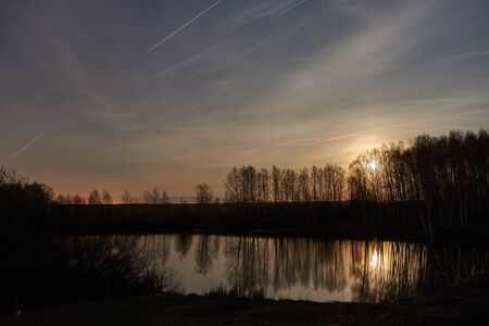 The sky with star at the lake in the twilight after sunset.の写真素材