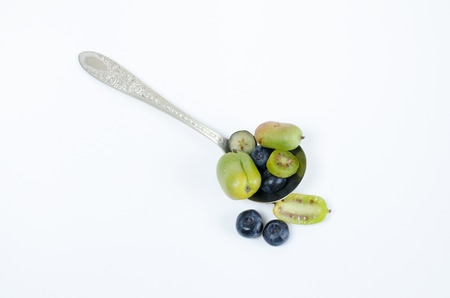Kiwi cherry and blueberries on white background.の写真素材