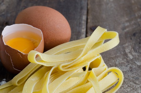 Homemade Pasta with egg on rustic wood bottom.の写真素材