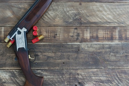 Shotgun of superimposed guns and cartridges. Space to write.の写真素材