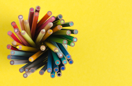 Color pencils in vertical on yellow background. Top view with space to write.の写真素材