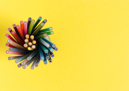 Color pencils in vertical on yellow background. Top view with space to write.の写真素材
