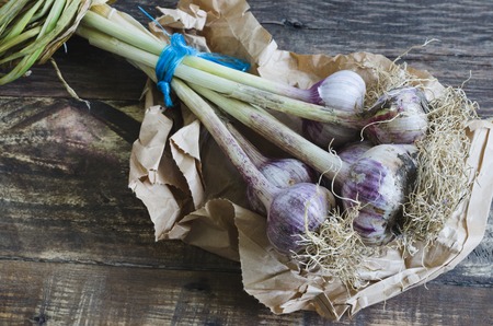 Natural garlics on wooden background. Top view.の写真素材