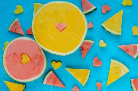 Colored watermelons in pieces with heart figures.の写真素材