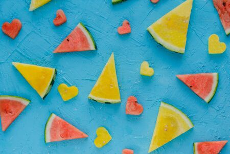 Colored watermelons in pieces with heart figures.の写真素材
