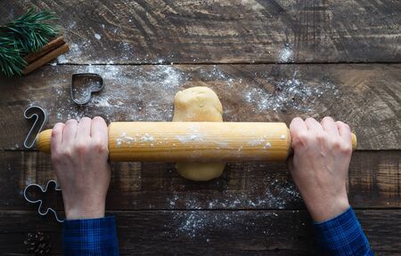 Preparation of cookie dough on wooden background. Top view. Christmas concept.
