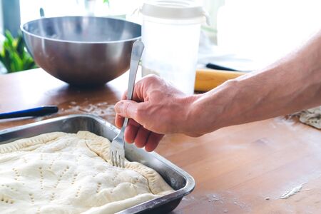 Preparation of patty for baking. Kitchen concept. Man's hand.