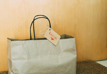 Paper shopping bag at the front door of the house. Concept of shopping.の写真素材