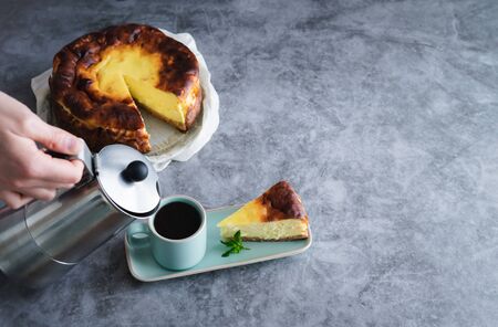 Cheesecake and hand serving coffee from the coffee maker. Copy space.の写真素材