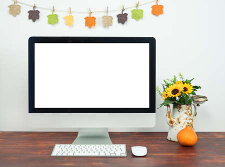 Workspace with blank computer screen and autumn decoration. Workspace with computer mockup.の写真素材