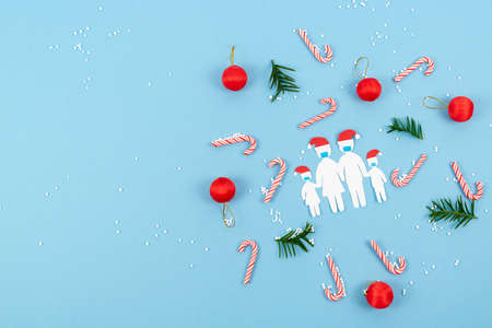 Paper cut family with masks at Christmas. New normality by coronavirus social distance at Christmas. Copy space.の写真素材