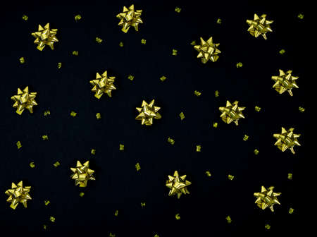 Christmas bows for decoration on a black background. Copy space. Top view. Flat lay.