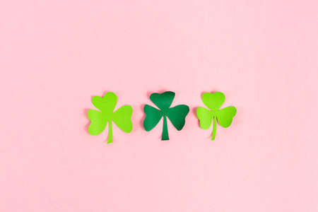 St. Patrick's Day celebration, three shamrocks on pink background. Copy space.の写真素材