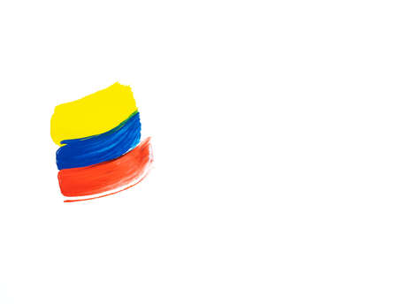 Brush painting on white background in yellow, blue and red colors. Copy space. Colombian flag.の写真素材