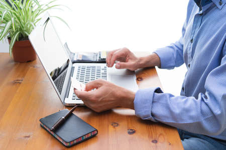 Man making online payments in front of the computer.