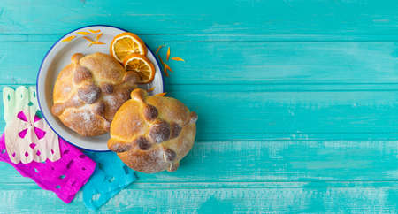 Pan de muerto on blue background, typical mexican food. Day of the dead celebration. Copy space. Top...
