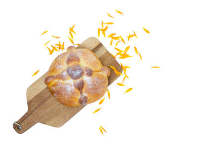 Pan de muerto on yellow background, typical mexican food. Day of the dead celebration. Copy space. Top view.の写真素材
