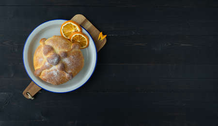 Pan de muerto on black background, typical mexican food. Day of the dead celebration. Copy space. Top view.の写真素材