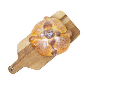 Pan de muerto on yellow background, typical mexican food. Day of the dead celebration. Copy space....