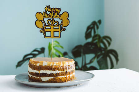 Cake with Birthday topper. Copy space. Blurred background.の写真素材