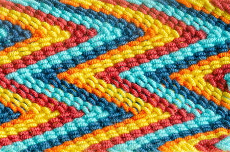 Macro of handmade Wayu weaving of colors and zig-zag shapes. Concept textures.