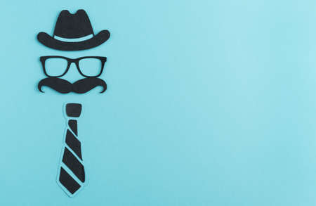 Cut paper figure in black color on blue background. Father's day concept. Man's day.の写真素材