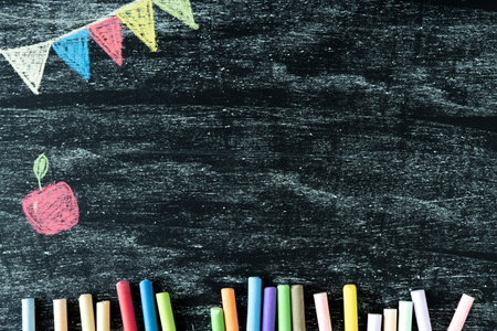 Back to class. Dark blackboard with an apple and flags painted with chalk. Space for copying.の写真素材