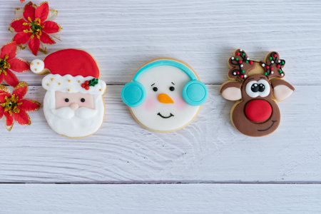 christmas biscuits decorated on a white wooden background.の写真素材