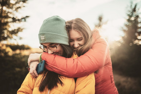 two girls embracing in nature