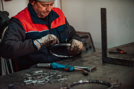 A worker in an industry preparing iron structures for weldingの写真素材