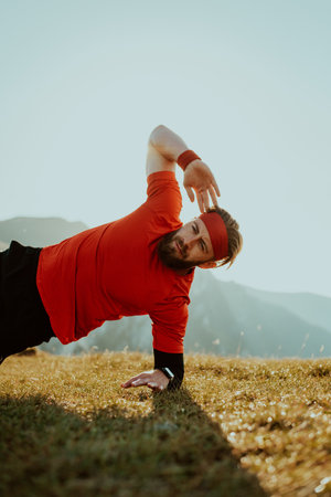 A man doing abs exercises on top of a mountainの写真素材