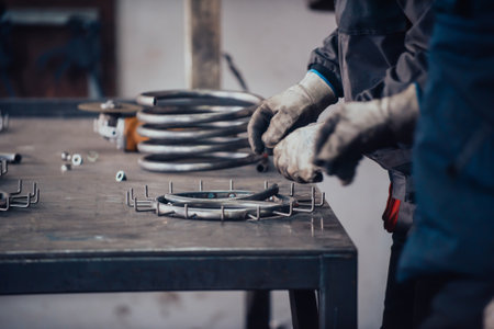 The locksmith measures the pieces of steel and preparing them for weldingの写真素材