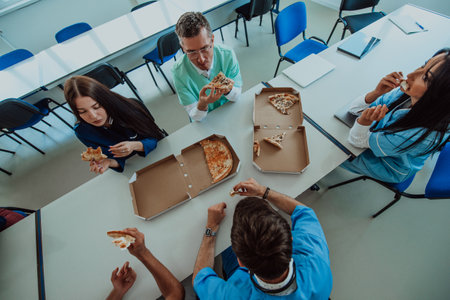 A group of medical technicians, nurses, and a doctor come together to enjoy a well-deserved pizza break in the modern hospitalの写真素材