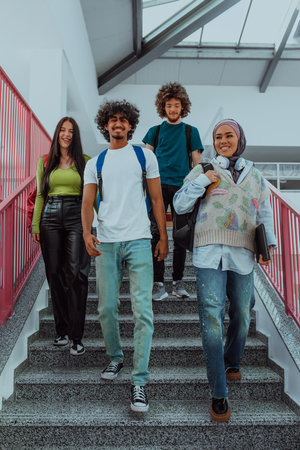 A modern group of students, including an Afro American student and a student wearing a hijab, walk together in the hallway of a modern university, reflecting diversity, inclusivity, and the pursuit of knowledge.の写真素材