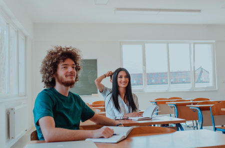 A group of diverse students engages in lively discussion as they educate themselves in a modern classroom, embracing the power of collaboration and knowledge exchange.の写真素材
