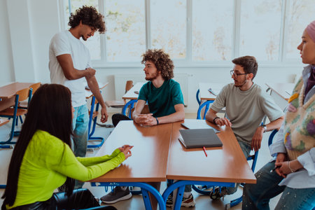 A diverse group of students gathers in a modern school classroom, passionately engaging in lively discussions about various projects, embracing teamwork and utilizing technology to enhance their learning experienceの写真素材